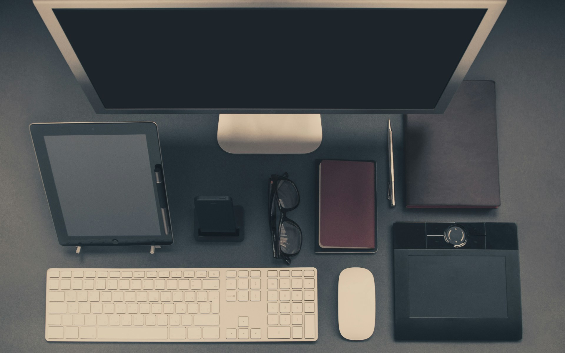 a desk with a computer and a keyboard